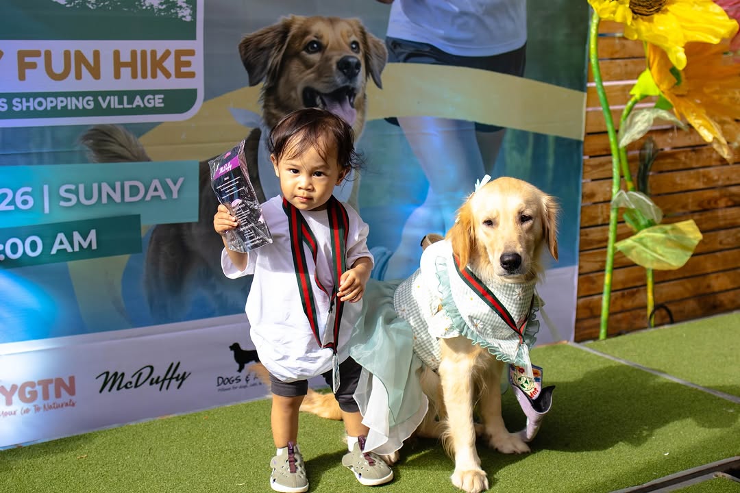 Dogs and their owners posing together